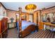 Large bedroom with a wooden four-poster bed and tiled floors at 2271 Keystone Rd, Tarpon Springs, FL 34688