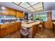 Bright kitchen features an island and wood cabinets at 2271 Keystone Rd, Tarpon Springs, FL 34688