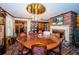 Formal dining room with large round table, fireplace, and display cabinets at 2271 Keystone Rd, Tarpon Springs, FL 34688