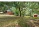 Wooded backyard with red and white barns at 2271 Keystone Rd, Tarpon Springs, FL 34688
