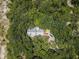 Aerial view of a house nestled in a wooded area at 2271 Keystone Rd, Tarpon Springs, FL 34688