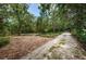 Private driveway leading into a wooded area at 2271 Keystone Rd, Tarpon Springs, FL 34688