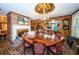 Round dining table with seating for eight, situated near a brick fireplace at 2271 Keystone Rd, Tarpon Springs, FL 34688