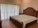 Main bedroom with wood floors, large windows, and a king-size bed at 4115 Murfield E Dr, Bradenton, FL 34203