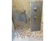 Walk-in shower with pebble floor and modern fixtures at 4115 Murfield E Dr, Bradenton, FL 34203