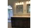 Double vanity bathroom with granite countertops and updated fixtures at 4115 Murfield E Dr, Bradenton, FL 34203