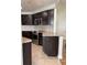 Modern kitchen with dark cabinets, granite counters and stainless steel appliances at 4115 Murfield E Dr, Bradenton, FL 34203
