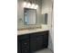 Updated bathroom with granite countertops, dark wood cabinets, and modern fixtures at 4115 Murfield E Dr, Bradenton, FL 34203