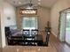 Spacious dining room with hardwood floors and access to patio at 4115 Murfield E Dr, Bradenton, FL 34203