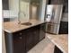 Modern kitchen with dark cabinets, granite counters, and stainless steel appliances at 4115 Murfield E Dr, Bradenton, FL 34203