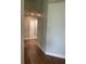 Long hallway with light walls and wood-look floors at 4115 Murfield E Dr, Bradenton, FL 34203