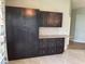 Modern kitchen with dark cabinets, granite countertops, and stainless steel appliances at 4115 Murfield E Dr, Bradenton, FL 34203