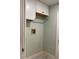 Bright laundry room with white cabinets and built-in shelving at 4115 Murfield E Dr, Bradenton, FL 34203
