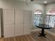Living room with large windows and built-in storage at 4115 Murfield E Dr, Bradenton, FL 34203