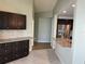 Modern kitchen with dark cabinets, granite counters and stainless steel appliances at 4115 Murfield E Dr, Bradenton, FL 34203
