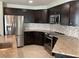 Modern kitchen with dark cabinets, granite counters and stainless steel appliances at 4115 Murfield E Dr, Bradenton, FL 34203