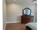 Bedroom with wood floors, dresser, and large mirror at 4115 Murfield E Dr, Bradenton, FL 34203