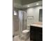 Updated bathroom with dark vanity and tile floors at 4115 Murfield E Dr, Bradenton, FL 34203