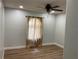 Bedroom with wood flooring, ceiling fan and neutral walls at 4115 Murfield E Dr, Bradenton, FL 34203