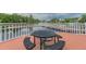 Community dock with a table and chairs overlooking the lake at 17809 Saint Lucia Isle Dr, Tampa, FL 33647