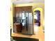 Kitchen with stainless steel refrigerator and view into living room at 32502 Summerglade Dr, Wesley Chapel, FL 33545