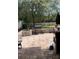 Brick paved patio, grill, and fenced backyard with trees at 32502 Summerglade Dr, Wesley Chapel, FL 33545
