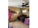 Bedroom with twin bed, ceiling fan and colorful decor at 32502 Summerglade Dr, Wesley Chapel, FL 33545