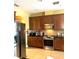 Modern kitchen with stainless steel appliances and wood cabinets at 32502 Summerglade Dr, Wesley Chapel, FL 33545