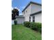 Side view of two-story house showcasing gray siding and landscaping at 32502 Summerglade Dr, Wesley Chapel, FL 33545