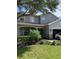 Two-story house with gray siding, stone accents, and landscaping at 32502 Summerglade Dr, Wesley Chapel, FL 33545