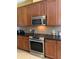 Kitchen with stainless steel appliances and wood cabinets at 32502 Summerglade Dr, Wesley Chapel, FL 33545