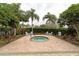 Relaxing hot tub area with surrounding landscaping at 8044 Stirling Falls Cir, Sarasota, FL 34243