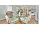 Kitchen and dining area with glass table and seashell patterned chairs at 308 S Port Royal Ln, Apollo Beach, FL 33572