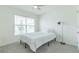 Bright bedroom with a double bed, window, and floor lamp at 810 Ace Outlaw Ave, Ruskin, FL 33570
