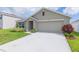 Single story home with two car garage and landscaped yard at 810 Ace Outlaw Ave, Ruskin, FL 33570