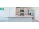 Modern kitchen island with granite countertop and stainless steel appliances at 810 Ace Outlaw Ave, Ruskin, FL 33570