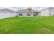 Green grassy backyard with a view of the home exterior at 810 Ace Outlaw Ave, Ruskin, FL 33570