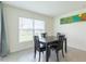 Bright dining area with a four-person table and view to backyard at 810 Ace Outlaw Ave, Ruskin, FL 33570