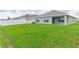 Large backyard with grassy area and home exterior view at 810 Ace Outlaw Ave, Ruskin, FL 33570