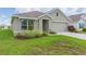 Single-story home with two-car garage and landscaped yard at 810 Ace Outlaw Ave, Ruskin, FL 33570