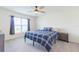 Cozy bedroom with a double bed, ceiling fan, and walk-in closet at 810 Ace Outlaw Ave, Ruskin, FL 33570