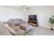 Spacious living room with sectional sofa and flat-screen TV at 810 Ace Outlaw Ave, Ruskin, FL 33570