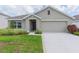 Single-story home with two-car garage and well maintained lawn at 810 Ace Outlaw Ave, Ruskin, FL 33570