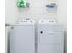 White washer and dryer in a well-lit laundry room at 810 Ace Outlaw Ave, Ruskin, FL 33570