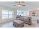Living room with sofa, ottoman, and view of backyard at 810 Ace Outlaw Ave, Ruskin, FL 33570
