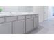 Modern bathroom with double sinks, gray cabinets, and marble countertops at 810 Ace Outlaw Ave, Ruskin, FL 33570
