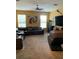 Relaxing living room featuring a sectional sofa and large TV at 32502 Summerglade Dr, Wesley Chapel, FL 33545