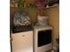 Laundry room with washer, dryer, and shelving for storage at 32502 Summerglade Dr, Wesley Chapel, FL 33545
