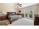 Spacious main bedroom with a king-size bed and private balcony access at 184 Valencia Cir, St Petersburg, FL 33716