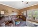 Living room with brown couches, a ceiling fan and access to a balcony at 184 Valencia Cir, St Petersburg, FL 33716